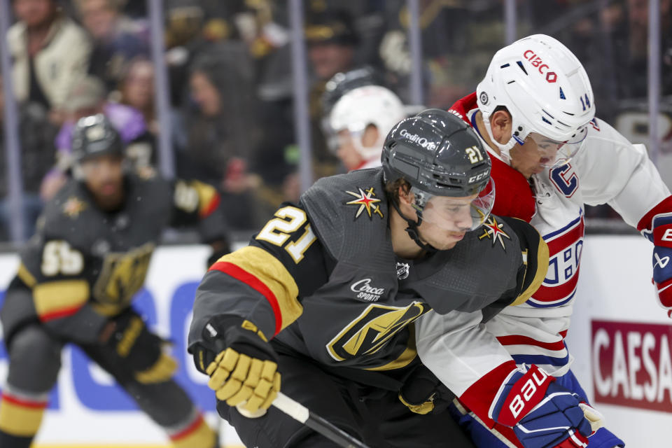 Vegas Golden Knights center Brett Howden (21) collides with Montreal Canadiens center Nick Suzuki (14) during the second period of an NHL hockey game, Monday, Oct. 30, 2023, in Las Vegas. (AP Photo/Ian Maule)