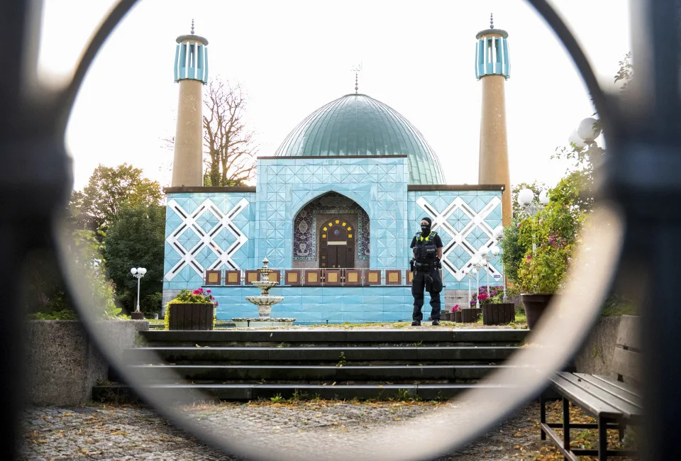 A police officer stands outside the Islamic Center Hamburg with the Imam Ali Mosque during a raid Wednesday, July 24, 2024, Hamburg, Germany. (Daniel Bockwoldt/dpa via AP)