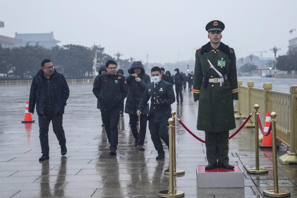 A Chinese paramilitary policeman stands guard in front of the Great Hall of the People before the opening session of the The National People's Congress (NPC) in Beijing, China, Tuesday, March 5, 2024. (AP Photo/Tatan Syuflana)