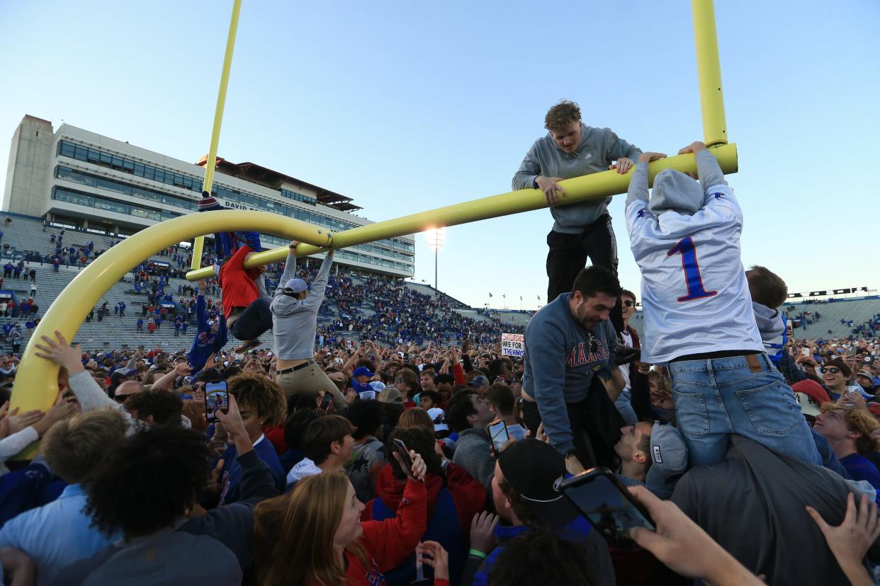 Kansas football fans start to climb the South end zone goal post inside David Booth Kansas Memorial Stadium after the Jayhawks beat Oklahoma State earlier this year 37-16.