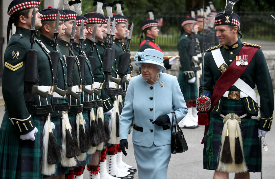 Queen Elizabeth II inspects the Balaklava Company, 5 Battalion The Royal Regiment of Scotland at the gates at Balmoral, as she takes up summer residence at the castle. (Photo by Andrew Milligan/PA Images via Getty Images)