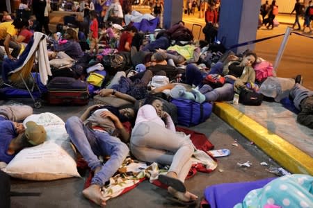 Venezuelan migrants sleep at the Binational Border Service Center of Peru in Tumbes