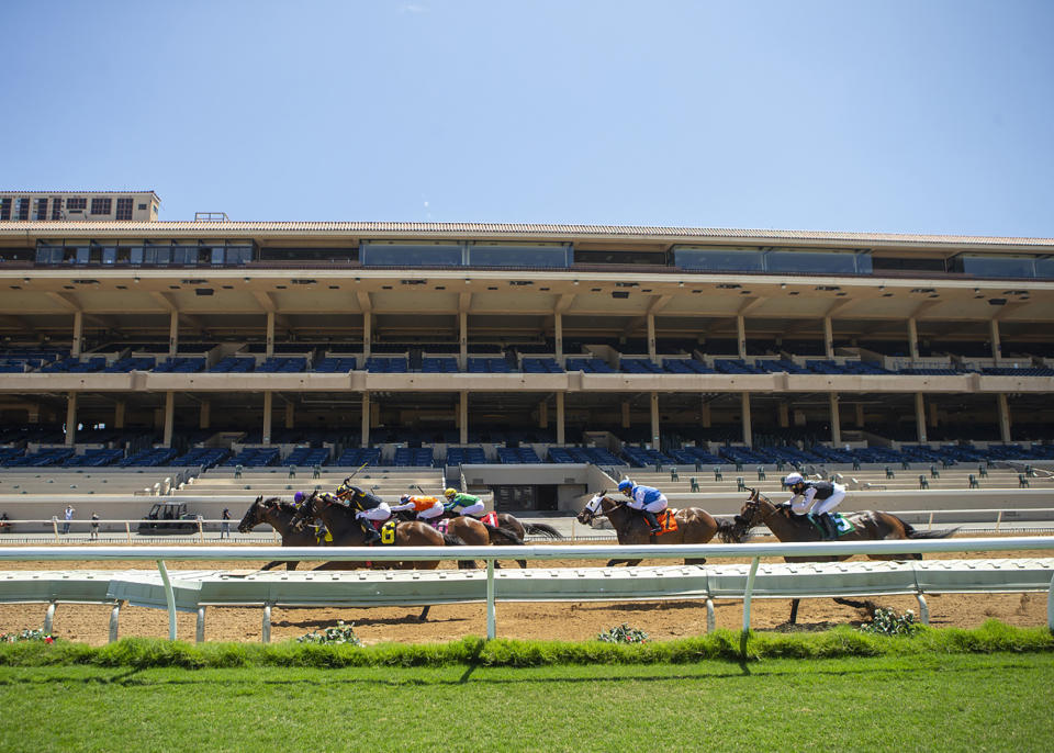 In this image provided by Benoit Photo, Secret Touch, left, with Umberto Rispoli aboard, wins the first race at Del Mar Thoroughbred Club, Friday, July 10, 2020, in Del Mar, Calif. (Benoit Photo via AP)