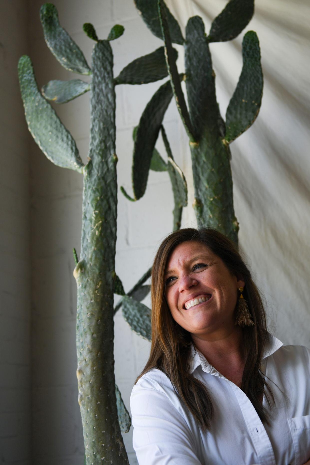 Mary Dunlap, owner of Wilder Plant Shop located inside The Good Market in Travelers Rest, S.C., poses with a cactus named Richard inside the shop on Friday, April 5, 2024.