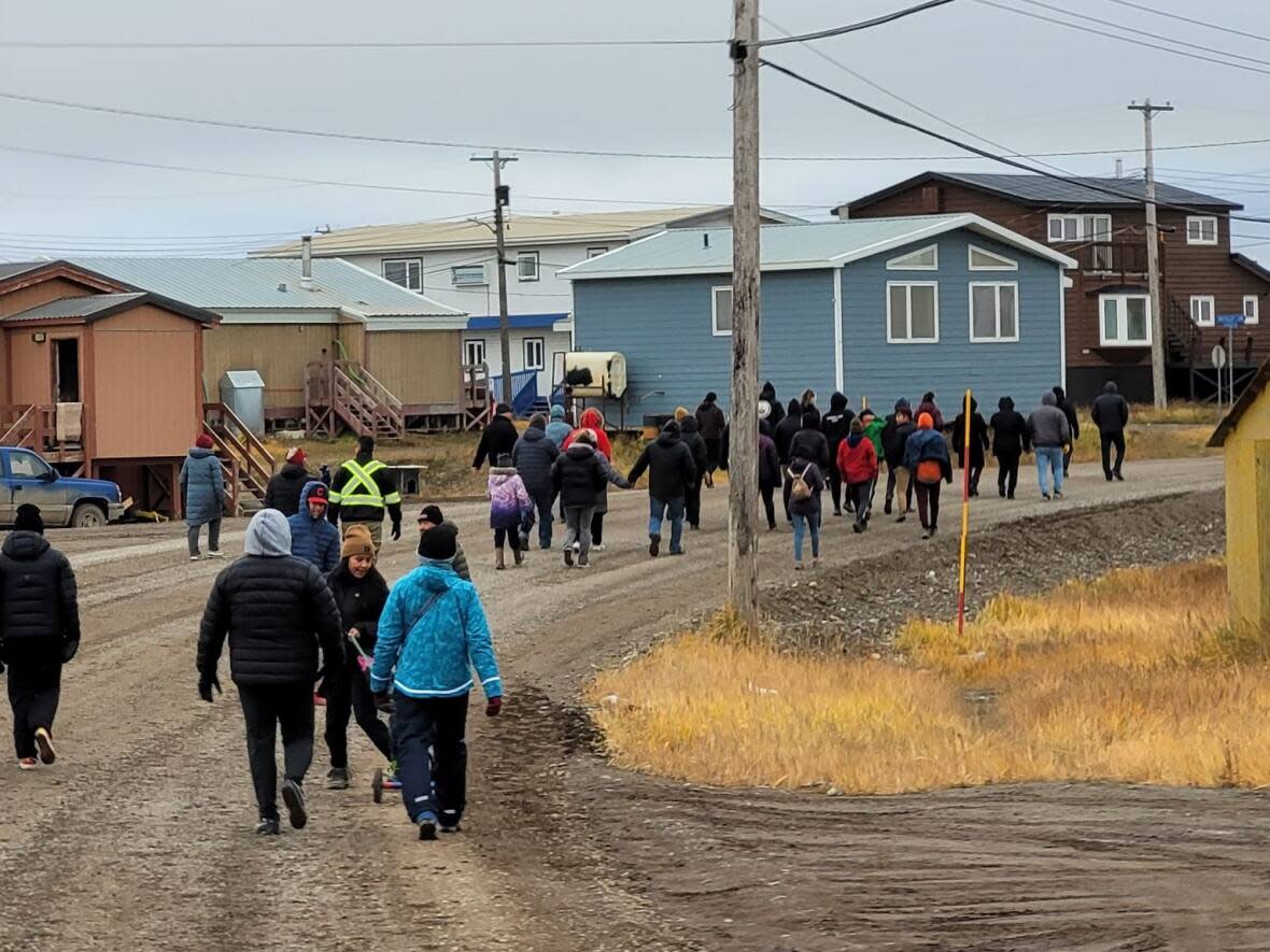 People gather in Tuktoyaktuk, N.W.T. for a vigil and suicide prevention walk on Sept. 21, 2022. (Submitted by Christina King (Taalrumiq) - image credit)