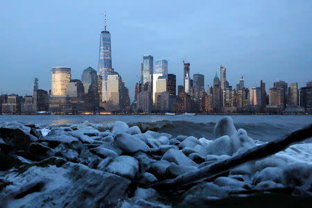 Downtown Manhattan in New York City is seen over ice that formed on the banks of the Hudson River during below freezing temperatures from Jersey City, New Jersey, U.S., February 1, 2019. REUTERS/Andrew Kelly