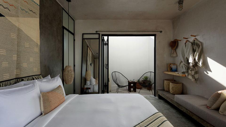 Drift Hotel in San Jose del Cabo's bedroom detail of minimal design and natural textures like wood, woven baskets and concrete