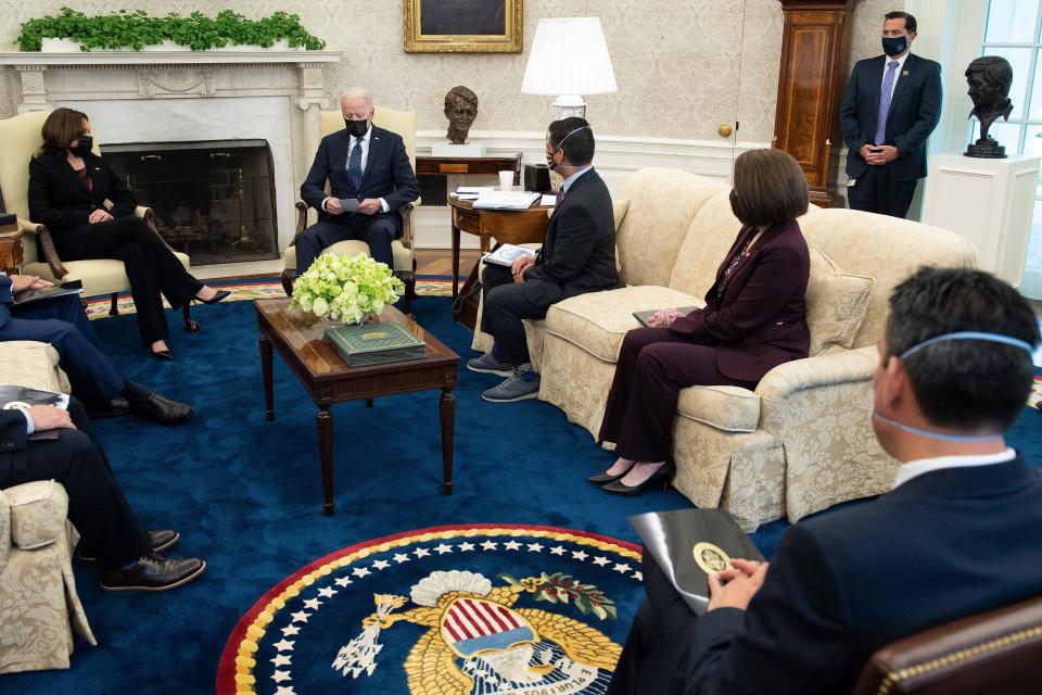 President Biden and Vice President Kamala Harris wait before a meeting with the Congressional Hispanic Caucus in the Oval Office of the White House on April 20, 2021. / Credit: BRENDAN SMIALOWSKI/AFP via Getty Images