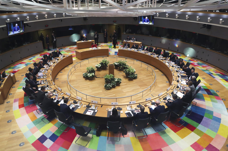 FILE - In this Feb. 21, 2020 file photo, European Union leaders meet at a round table during an EU summit in Brussels. European Union leaders are convening by video conference Thursday, March 26, 2020, for their third summit in three weeks, as they battle to contain the spread of the coronavirus. The new coronavirus causes mild or moderate symptoms for most people, but for some, especially older adults and people with existing health problems, it can cause more severe illness or death. (Yves Herman, Pool Photo via AP, File)