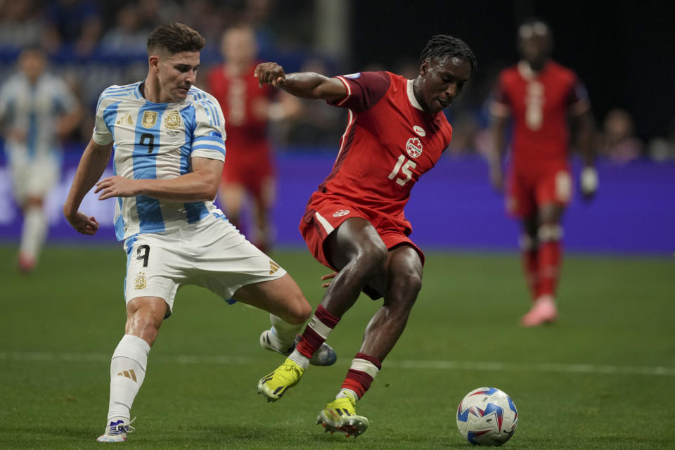 Argentina's Julian Alvarez, left, and Canada's Moise Bombito battle for the ball during a Copa America Group A soccer match in Atlanta, Thursday, June 20, 2024. (AP Photo/Jason Allen)