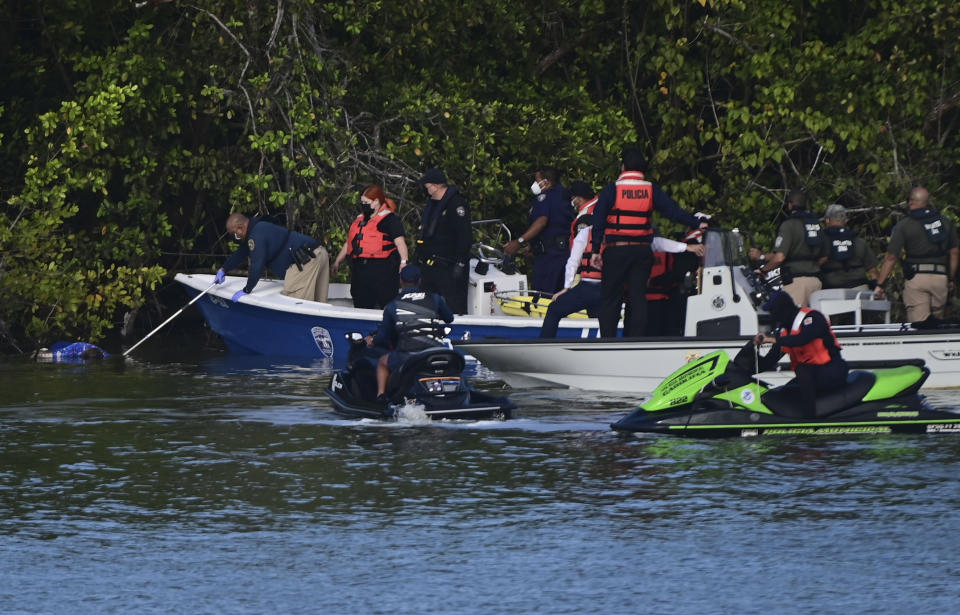 Authorities retrieve the body of 27-year-old Keishla Rodriguez, left, from the San Jose lagoon after she was reported missing in San Juan, Puerto Rico, Saturday, May 1, 2021. A federal judge on Monday ordered Puerto Rican boxer Félix Verdejo held without bail after he was charged in the death of Rodriguez, his pregnant lover. (AP Photo/Carlos Giusti)