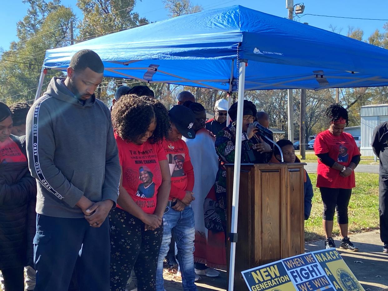 Members of Jerome Stevenson's family and others pray at a Dec. 29 news conference about the 26-year-old's death while in custody at an Avoyelles Parish jail facility. An inmate and two correctional deputies have been arrested in connection with Stevenson's death.