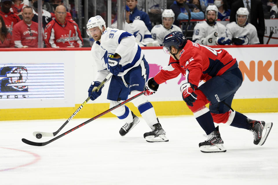 Tampa Bay Lightning center Steven Stamkos (91) skates with the puck against Washington Capitals defenseman Martin Fehervary (42) during the second period of an NHL hockey game, Saturday, Oct. 16, 2021, in Washington. (AP Photo/Nick Wass)