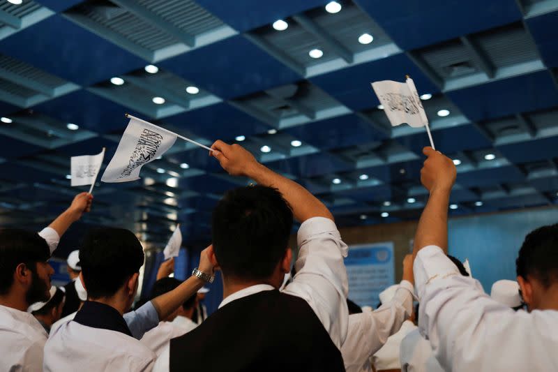 Taliban supporters hold an Islamic Emirate of Afghanistan flag at the second-anniversary ceremony of the takeover of Kabul by the Taliban in Kabul