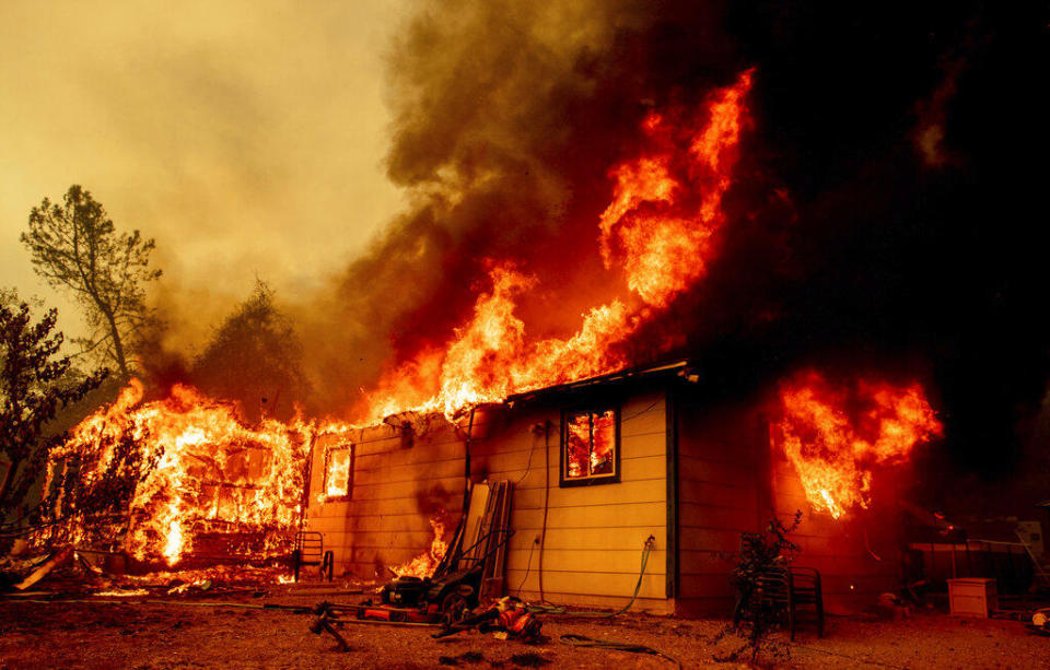 Flames consume a house near Old Oregon Trail as the Fawn Fire burns about 10 miles north of Redding in Shasta County, California on September 23, 2021. / Credit: Ethan Swope/AP