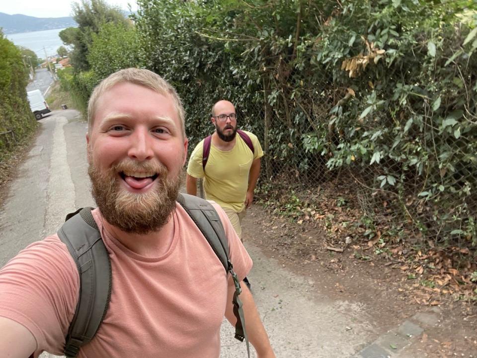 The author and his husband looking tired while walking on a dirt path