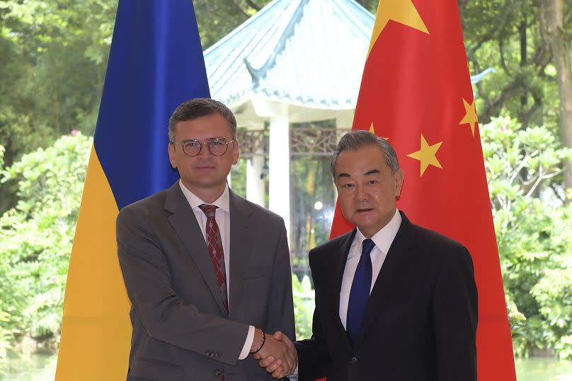 Ukraine's Foreign Minister Dmytro Kuleba poses with China's Foreign Minister Wang Yi before a meeting in Guangzhou, China.