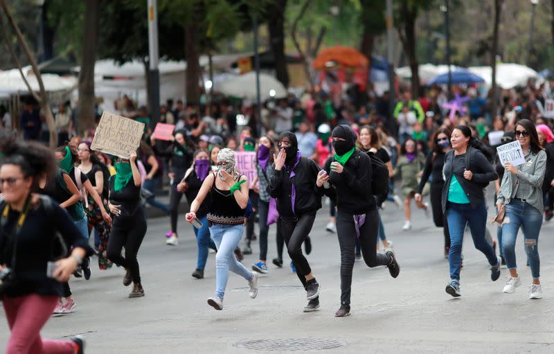 People take part in a protest against gender-based violence in downtown of Mexico City