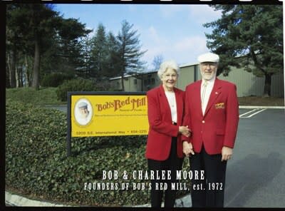 Bob and Charlee in front of old Bob's Red Mill sign