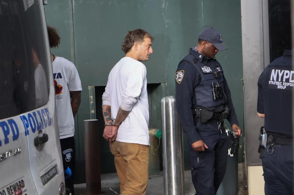 James Carlson being led by cops after his arrest. William Farrington