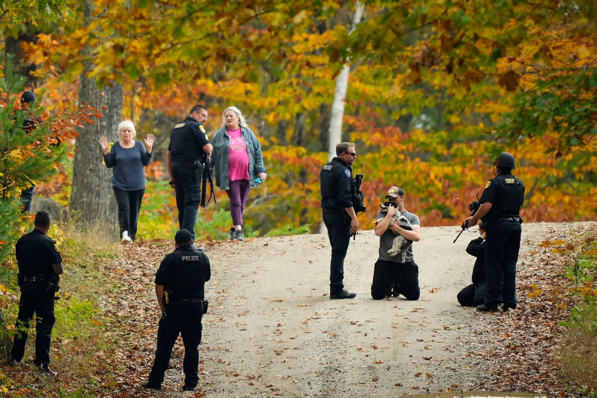Police temporarily detain residents on Friday as they hunt for the suspect in Wednesday’s mass shooting in Maine, USA (AP)