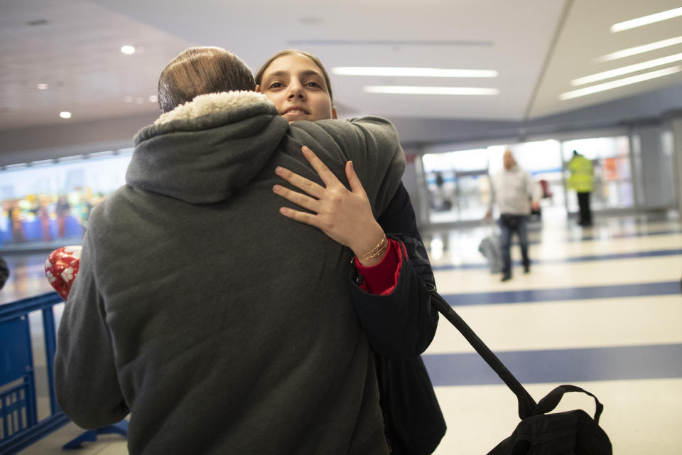 In this Dec. 3, 2019, photo, Mohammed Hafar hugs his daughter Jana after she arrives at JFK Airport in New York. Jana had been forced by President Donald Trump's travel ban to stay behind in Syria for months while her father, his wife and son Karim started rebuilding their lives in Bloomfield, N.J., with no clear idea of when the family would be together again. Mohammed was part of a federal lawsuit filed in August of this year over the travel ban waiver process. (AP Photo/Mary Altaffer)