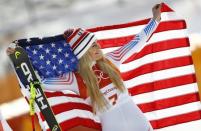 Alpine Skiing - Pyeongchang 2018 Winter Olympics - Women's Downhill - Jeongseon Alpine Centre - Pyeongchang, South Korea - February 21, 2018 - Bronze medallist Lindsey Vonn of the U.S. celebrates with the U.S. flag during the flower ceremony. REUTERS/Kai Pfaffenbach