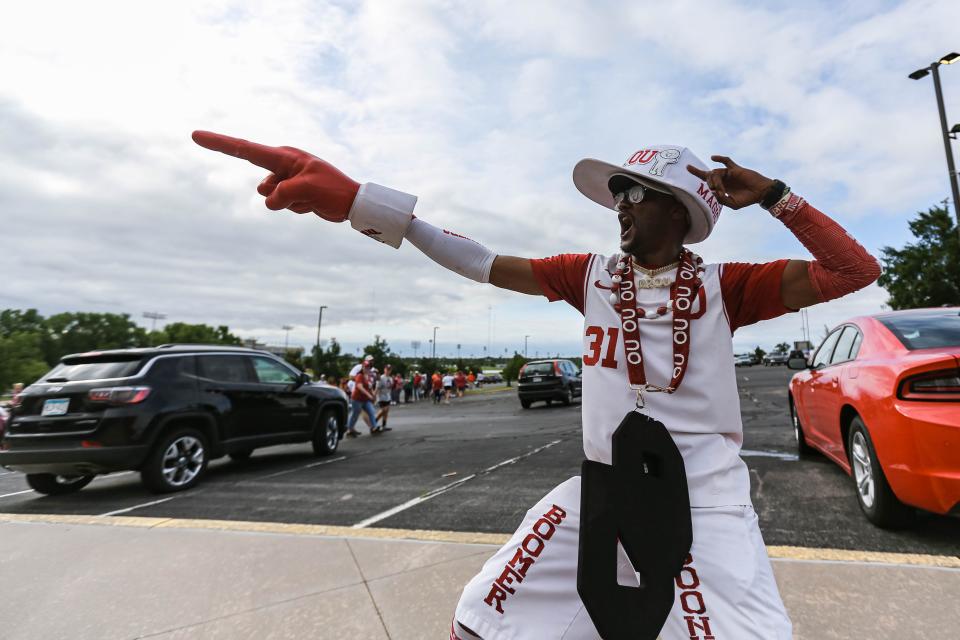 Antonio Record "Mr. OU" chants "Boomer, Sooner" with fans before Game 1 of the Women's College World Series finals between the Sooners and Texas on Wednesday outside USA Softball Hall of Fame Stadium.