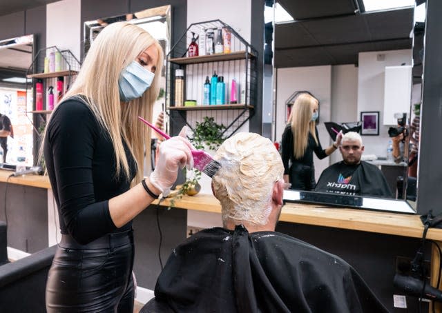 Bart Horgan receives a free 'Phil Foden' hair cut from Maisy Salisbury-Taylor at Simon Townley hair salon in Burnley, Lancashire, who are offering free hair cuts in the styles of England players, ahead of the Euro 2020 final