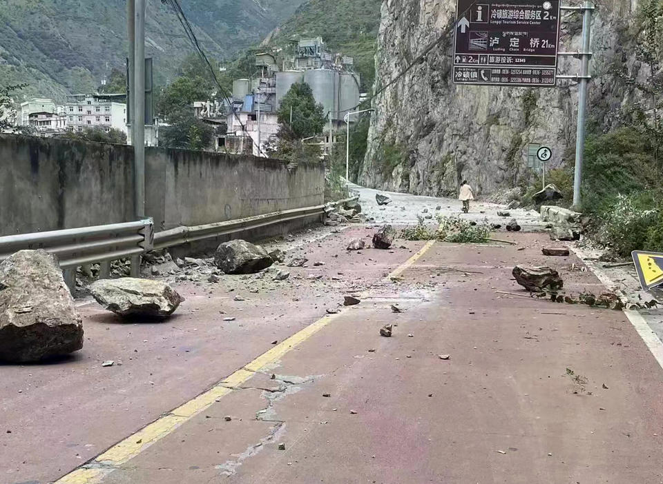 In this photo provided by China's Xinhua News Agency, fallen rocks are seen on a road near Lengqi Town in Luding County of southwest China's Sichuan Province Monday, Sept. 5, 2022. A strong earthquake killed multiple people, triggered landslides and shook residents in a major city under lockdown in southwestern China on Monday, state media reported.(Xinhua via AP)