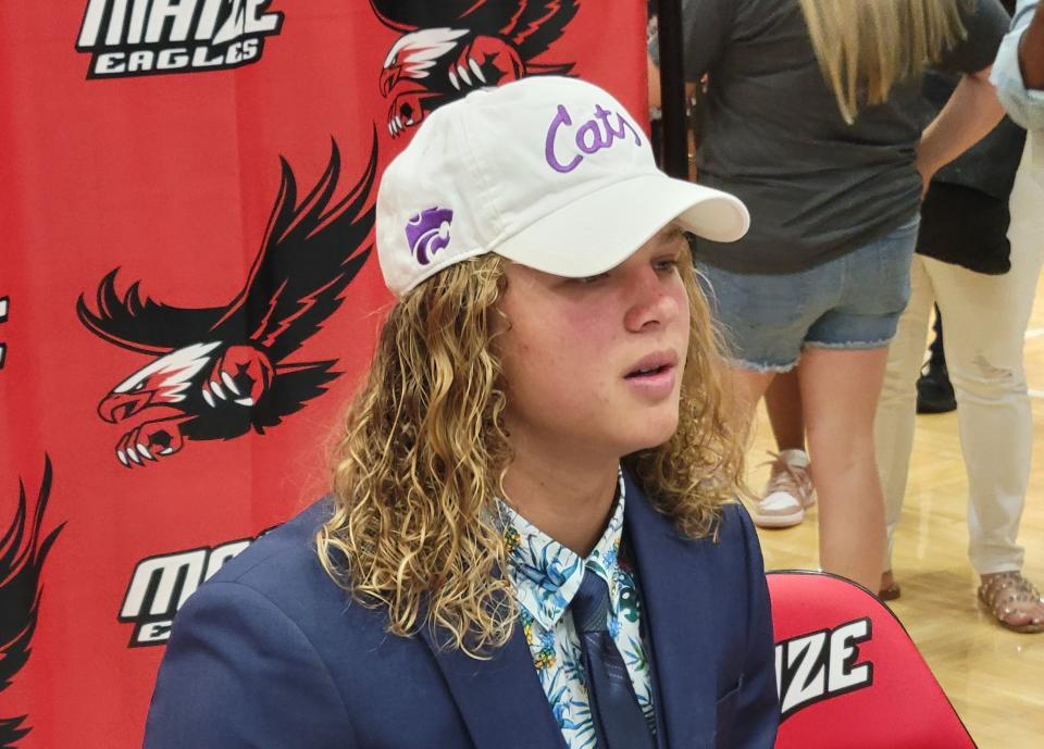 Maize  from media members after announcing his commitment to Kansas State on Tuesday at Maize High School.