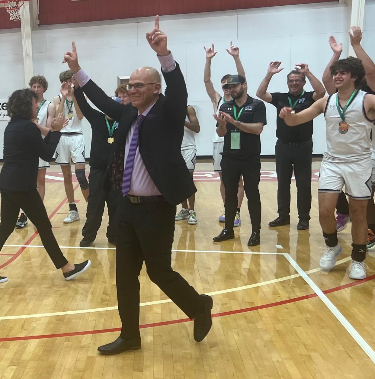12. Coach Andy Feltz and DeSales celebrate after winning the Division II boys volleyball state championship