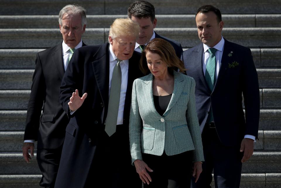 President Donald Trump confers with House Speaker Nancy Pelosi, D-Calif., while departing a St. Patrick's Day celebration at the Capitol in Washington, March 14, 2019.