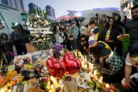 Mourners gather in Microsoft Square near the Staples Center to pay respects to Kobe Bryant after a helicopter crash killed the retired basketball star, in Los Angeles