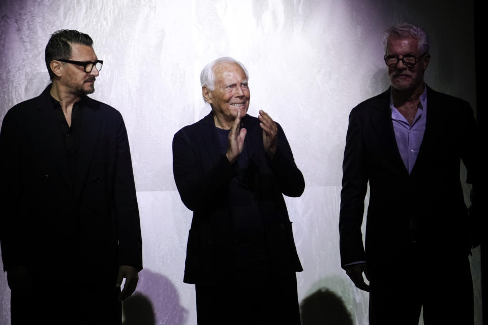 Fashion designer Giorgio Armani is flanked by Gianluca Dell'Orco, from the style studio, and Leo Dell'Orco at the end of the Giorgio Armani Men's Spring Summer 2025 fashion show, that was presented in Milan, Italy, Monday, June 17, 2024. (AP Photo/Luca Bruno).