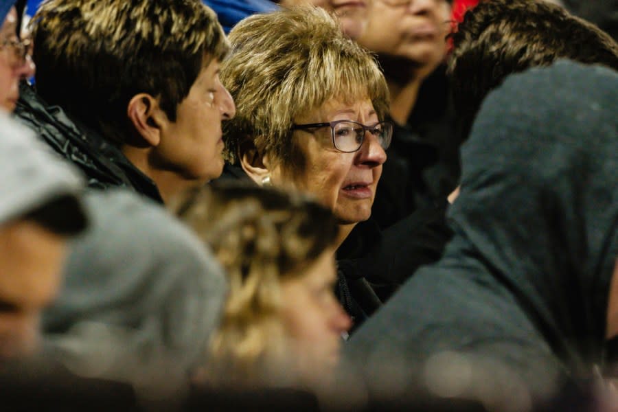 A woman cries during a community prayer vigil, Tuesday, Nov. 14, 2023, at the Tuscarawas Valley Schools football stadium in Zoarville, Ohio. A charter bus filled with high school students was rear-ended by a semitruck on an Ohio highway earlier in the day, leaving several people dead and multiple others injured. (Andrew Dolph/Times Reporter via AP)