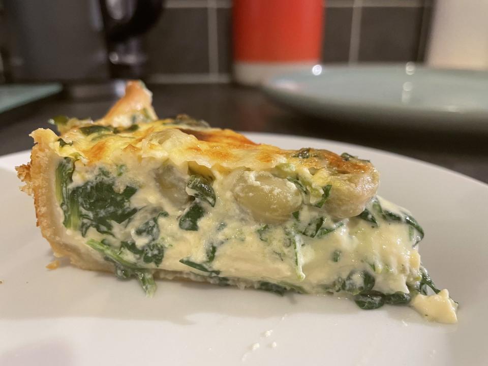 A slice of Coronation Quiche, viewed from the side.
