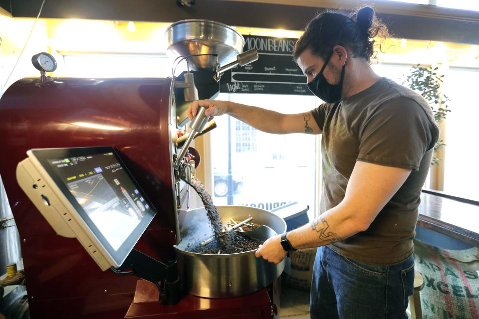 Owner Aaron Baer roasts espresso beans April 21, 2022, at New Moon Cafe, 401 N. Main St., in Oshkosh. The cafe started roasting its own coffee beans seven years ago and is the only place in Oshkosh that does so.