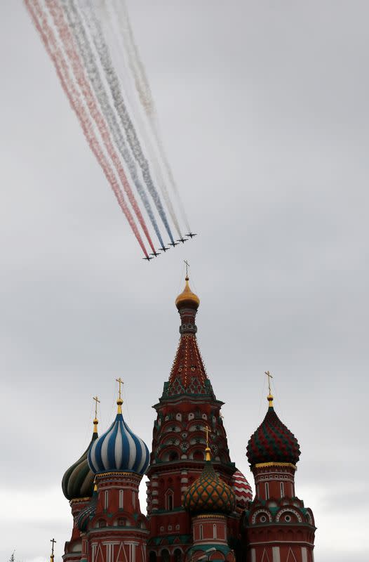 Su-25 jet aircraft release smoke in the colours of the Russian state flag above St. Basil's Cathedral during an air parade on Victory Day in central Moscow