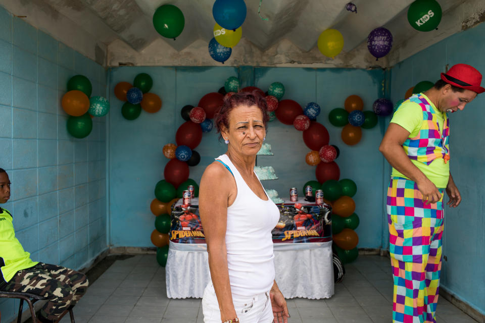 Marta celebrates her grandson's birthday in Cuba on May 27, 2018. She is able to return frequently and enjoys being able to bring small comforts to her family. Her main motivation for migrating to the U.S. was to be able to provide for her kids and grandson. When she returns to Las Yaguas, her block in Havana, everyone knows her. She still feels at home. | Lisette Poole