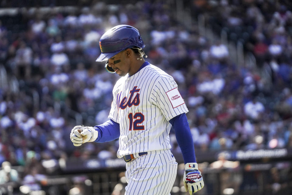 New York Mets' Francisco Lindor heads to the dug out after grounding out into 7th inning, during a baseball game against San Diego Padres, Wednesday, April 12, 2023, in New York. (AP Photo/Bebeto Matthews)