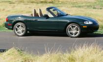 <p>Ten years after it introduced the first MX-5 Miata BRG model, Mazda again offers a limited-edition Miata with British Racing Green paint. The 2001 special edition gets the same equipment as the uplevel Miata LS trim, as well as polished 16-inch aluminum wheels, a wood-rimmed Nardi steering wheel, a six-speed manual transmission, chrome gauge trim, and a tan interior and top<br></p><p>Also in 2001, Mazda freshens the MX-5 Miata's headlights and taillights, adds variable intake-valve timing for the 1.8-liter (bringing horsepower up to 155 ponies), and makes 15-inch wheels standard<br> </p>