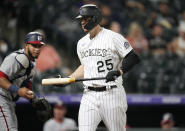 Colorado Rockies' C.J. Cron, right, reacts after striking out as Washington Nationals catcher Keibert Ruiz looks on in the fourth inning of a baseball game Monday, Sept. 27, 2021, in Denver. (AP Photo/David Zalubowski)