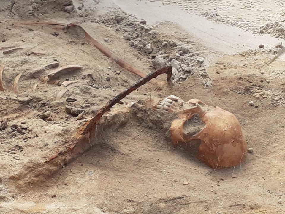 Female "vampire" with a sickle across her throat found in Pień, Poland.