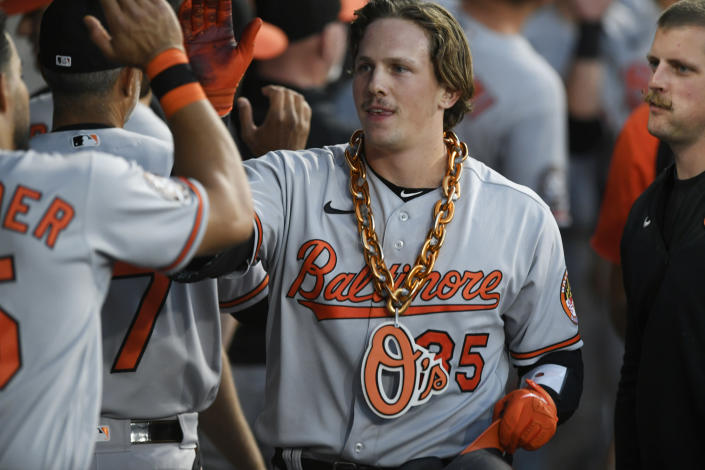Baltimore Orioles' Adley Rutschman (35) is congratulated in the dugout after hitting a two-run home run against the Chicago White Sox during the fourth inning of a baseball game Thursday, June 23, 2022, in Chicago. (AP Photo/Paul Beaty)