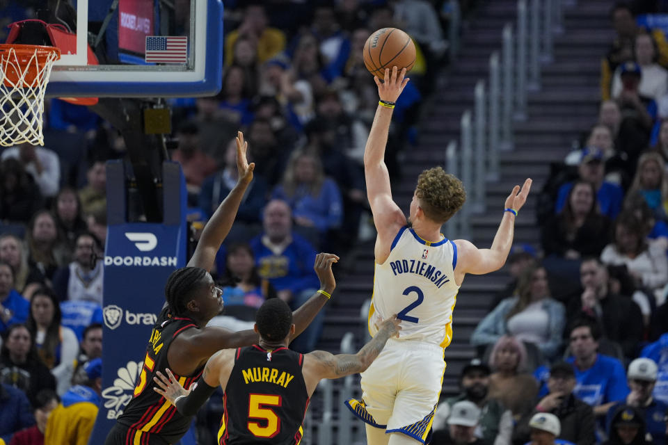 Golden State Warriors guard Brandin Podziemski (2) shoots over Atlanta Hawks center Clint Capela, left, during the first half of an NBA basketball game, Wednesday, Jan. 24, 2024, in San Francisco. (AP Photo/Godofredo A. Vásquez)