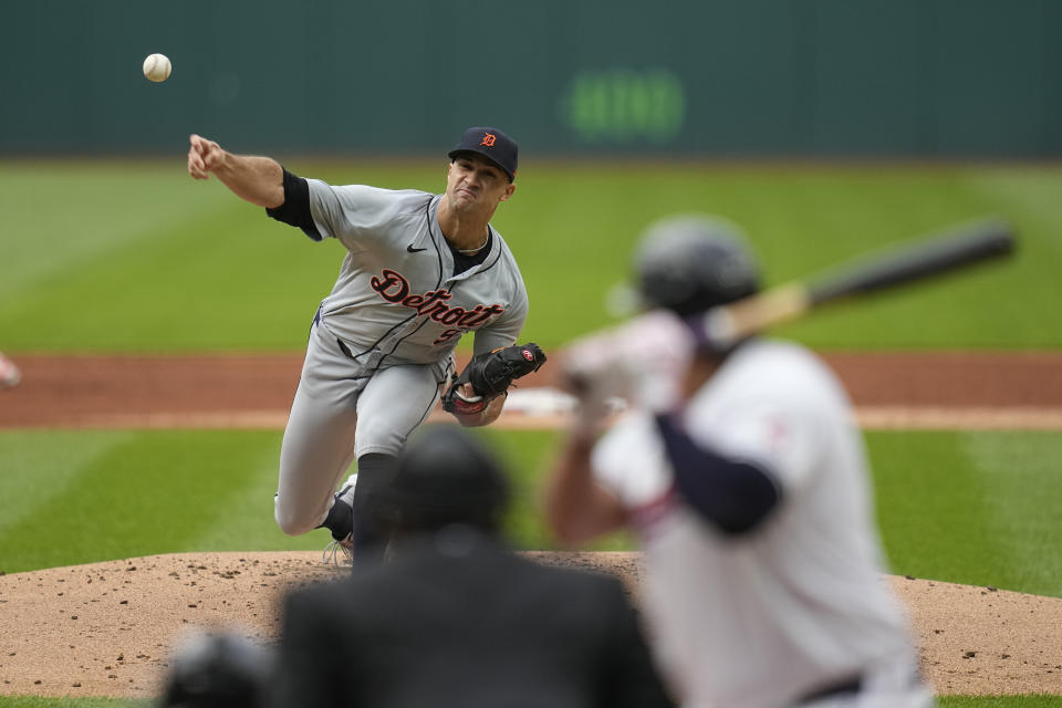 Detroit Tigers' Jack Flaherty, top left, pitches to Cleveland Guardians' Josh Naylor, right, in the first inning of a baseball game Monday, May 6, 2024, in Cleveland. (AP Photo/Sue Ogrocki)