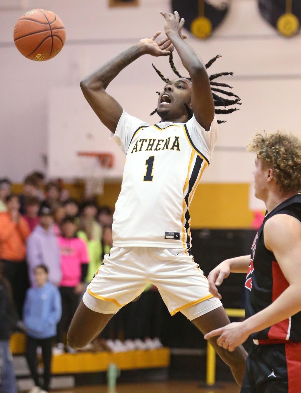 Athena's Khorie Reaves has the ball stripped by Hilton's Timothy Graziano as he goes up for a jump shot in the first quarter.