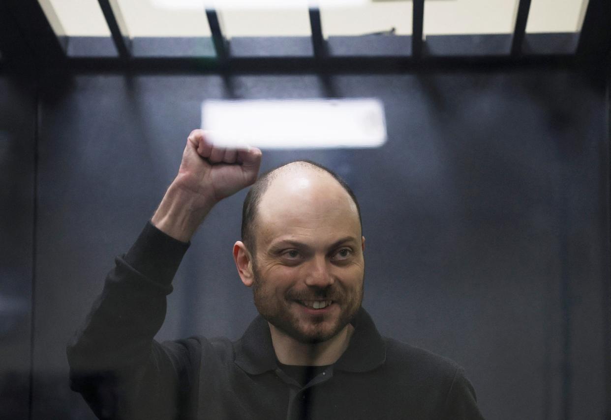 Jailed Russian opposition figure Vladimir Kara-Murza gestures as he stands behind a glass wall of an enclosure for defendants during a court hearing to consider an appeal against his prison sentence in Moscow (REUTERS)
