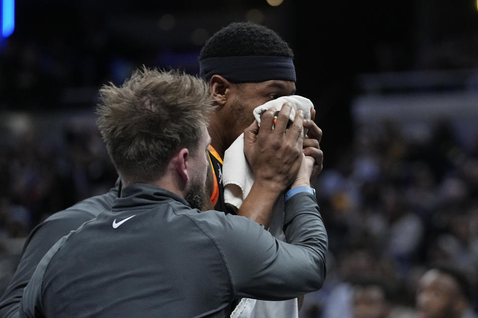 Phoenix Suns' Bradley Beal is helped off the court during the second half of the team's NBA basketball game against the Indiana Pacers, Friday, Jan. 26, 2024, in Indianapolis. (AP Photo/Darron Cummings)